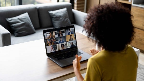 Woman talking to some colleagues in an online business meeting while working at home