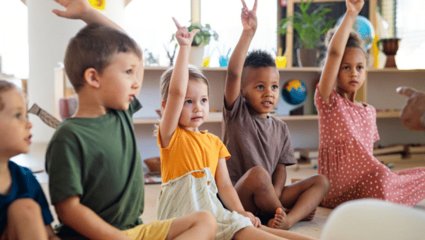 kids raising their hands classroom